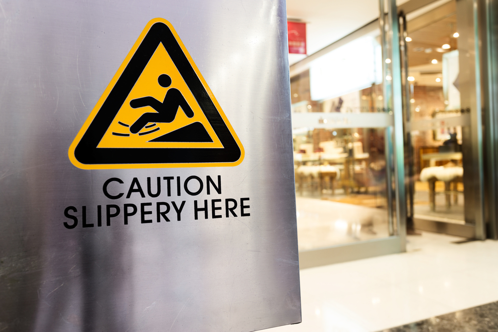 What to Do After a Slip and Fall Accident - caution sign at store